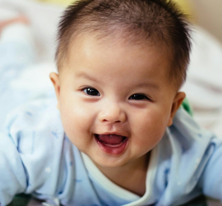baby smiling and lying forward